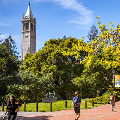 Campanile in background of campus grounds