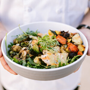 Student holds bowl of salad