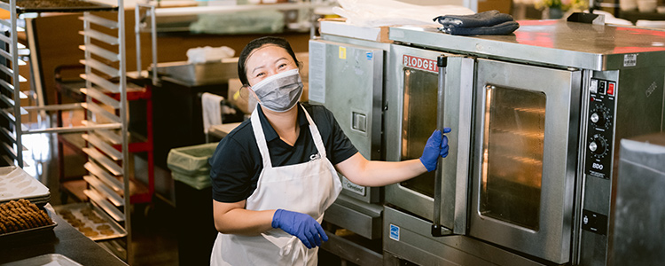 Restaurant staff member working in kitchen