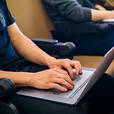 Student typing on computer